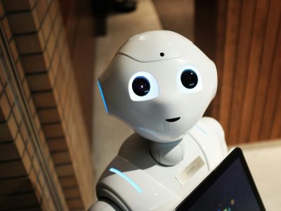 A futuristic humanoid robot in an indoor Tokyo setting, showcasing modern technology.